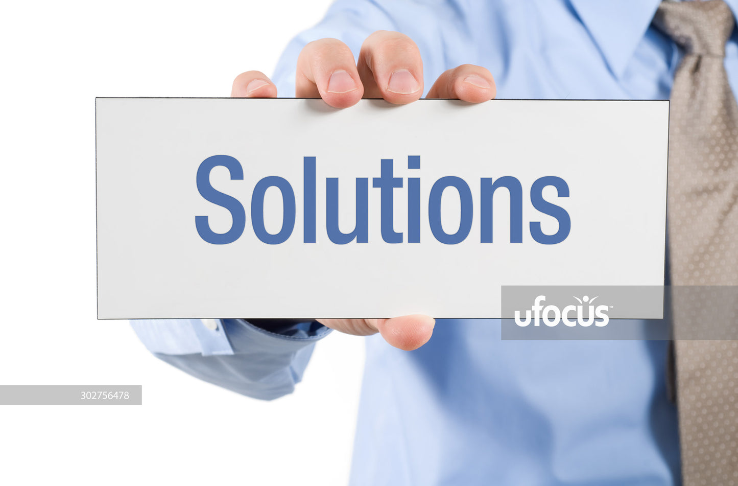 Businessman holding solutions sign stock photo