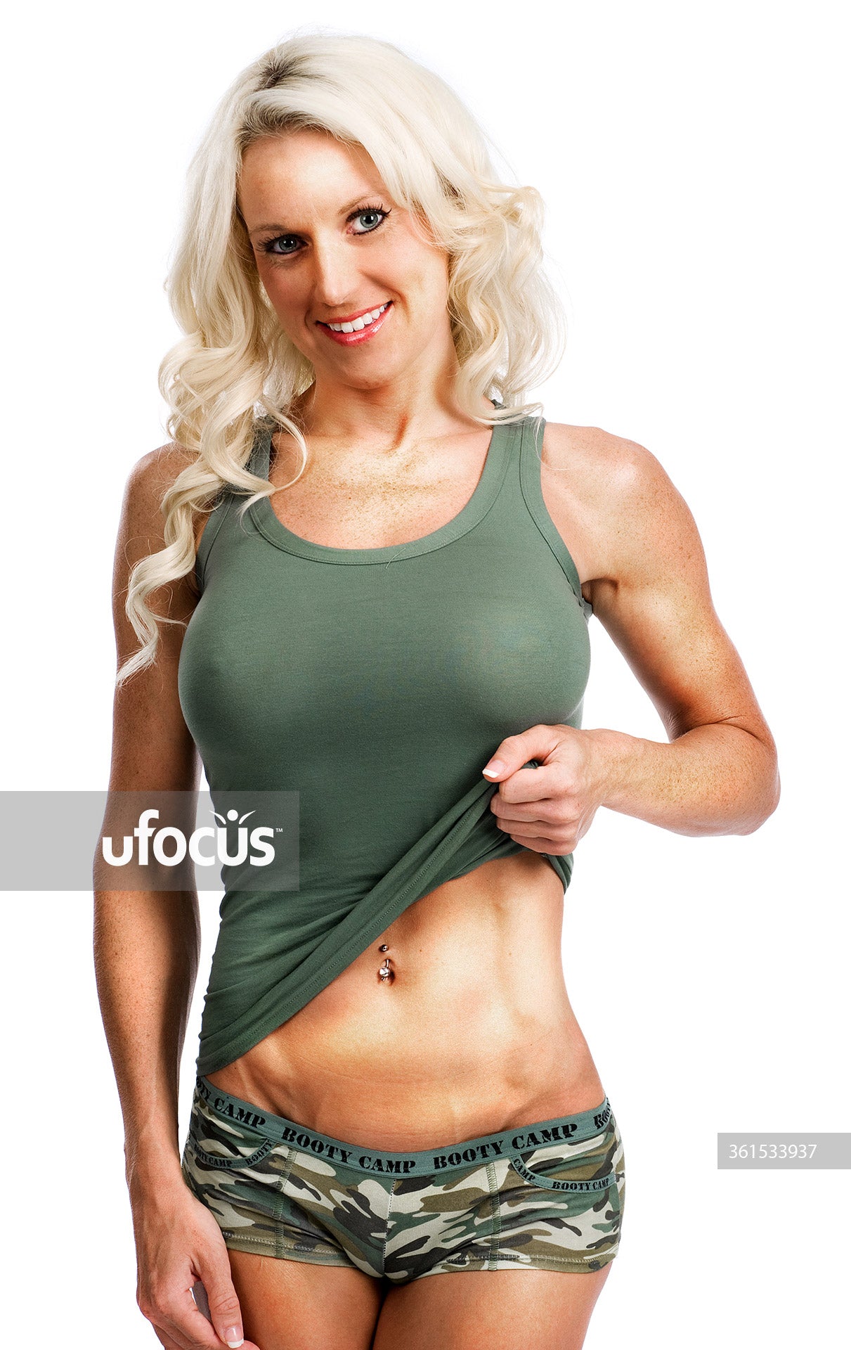 Smiling happy fit woman showing her abs stock photo