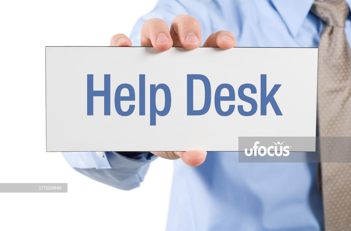 Businessman holding help desk sign stock photo