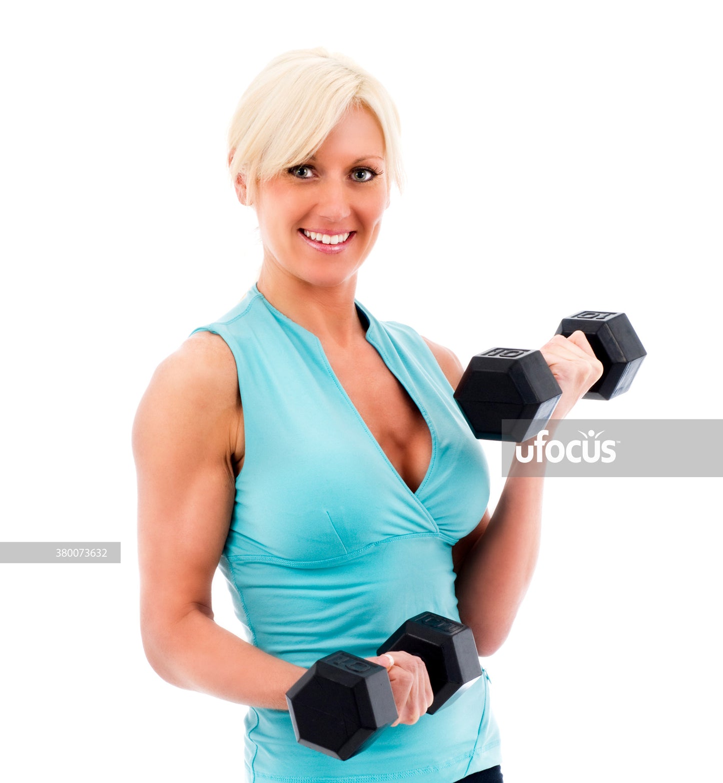 Beautiful female fitness model holding weights stock photo