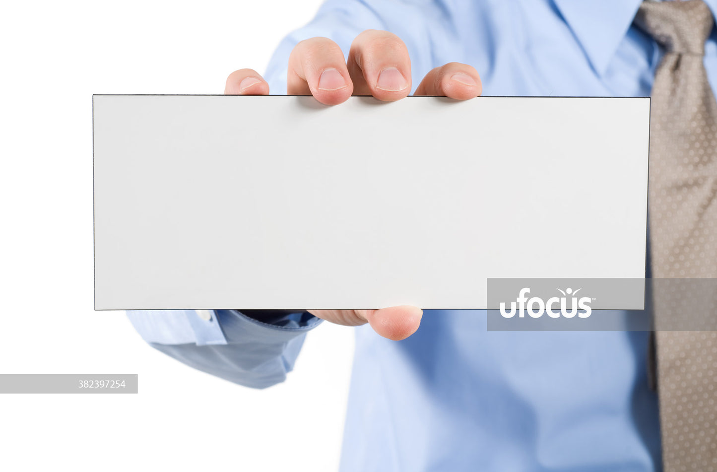 Businessman holding a blank white sign stock photo