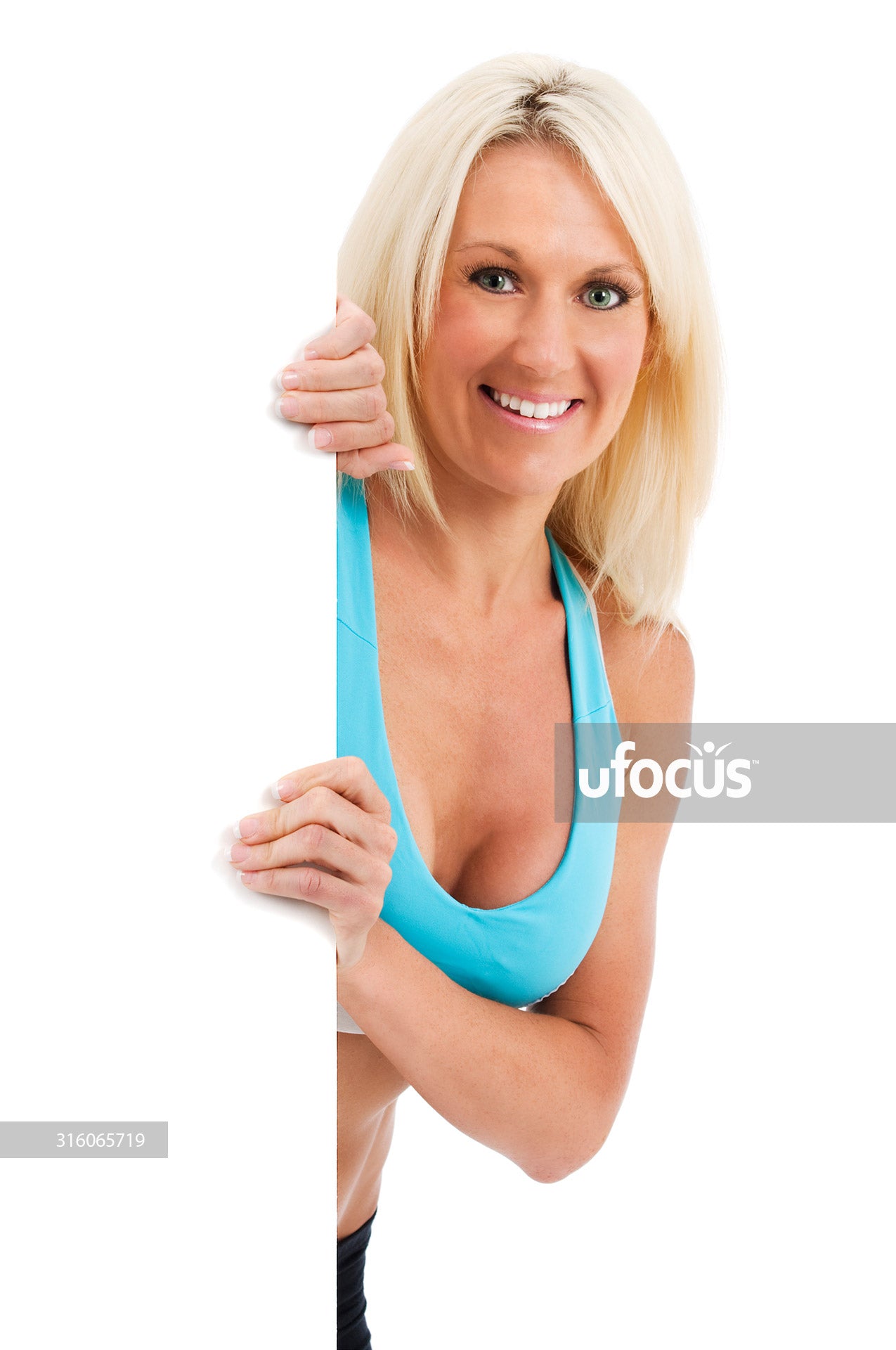 Happy fit woman holding blank sign stock photo