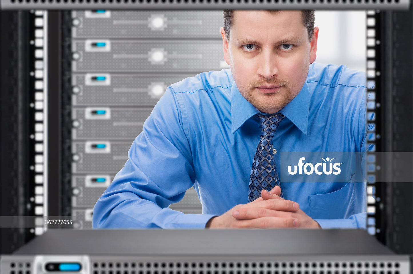Network Administrator looking through network server rack