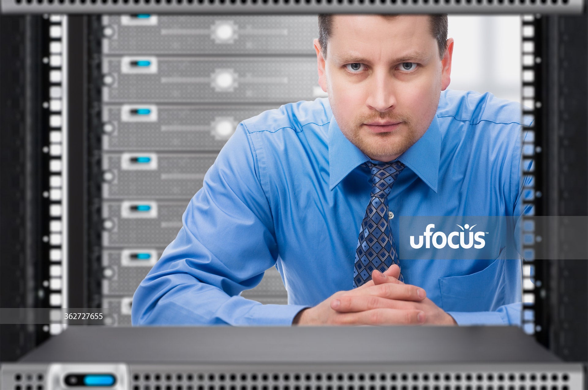 Network Administrator looking through network server rack