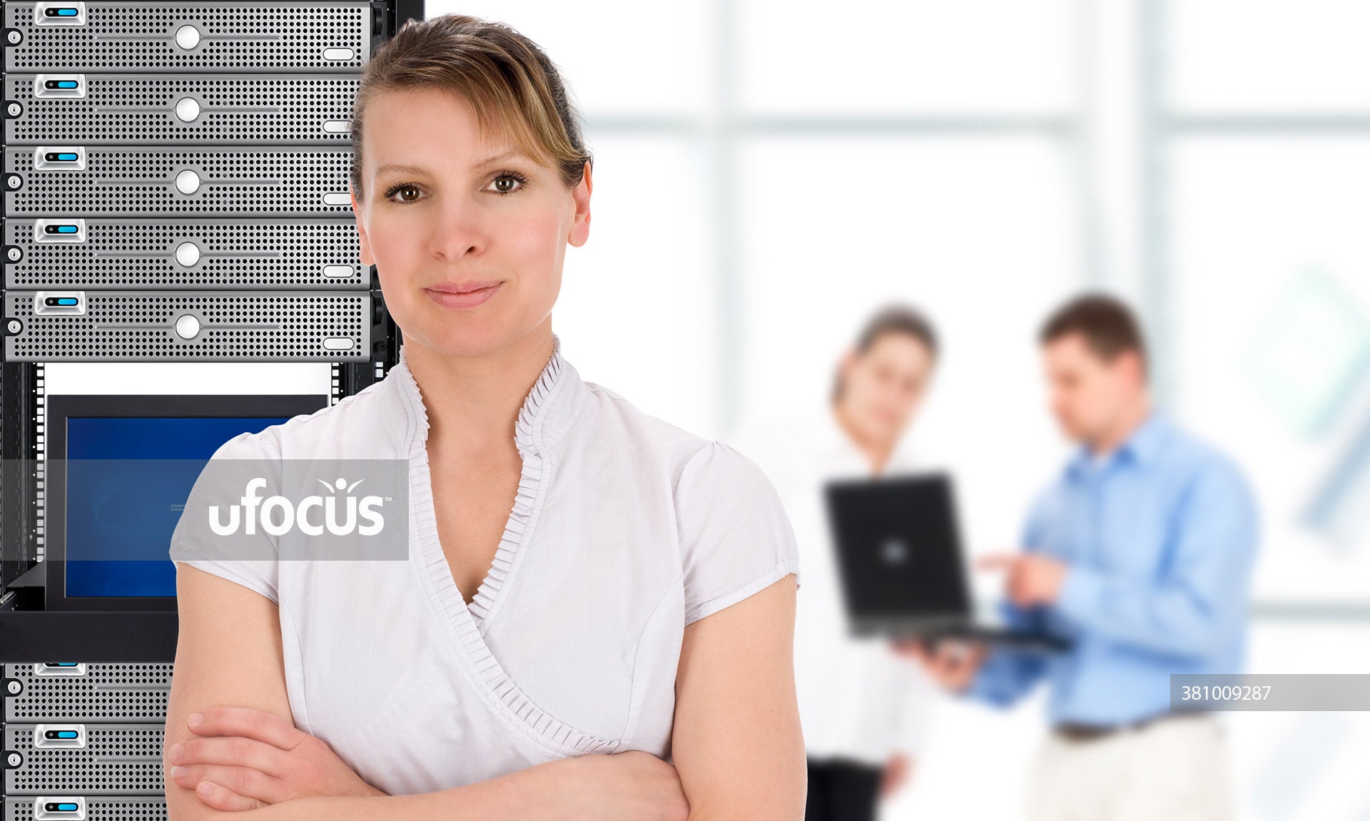 IT support team with woman in front of network servers stock photo