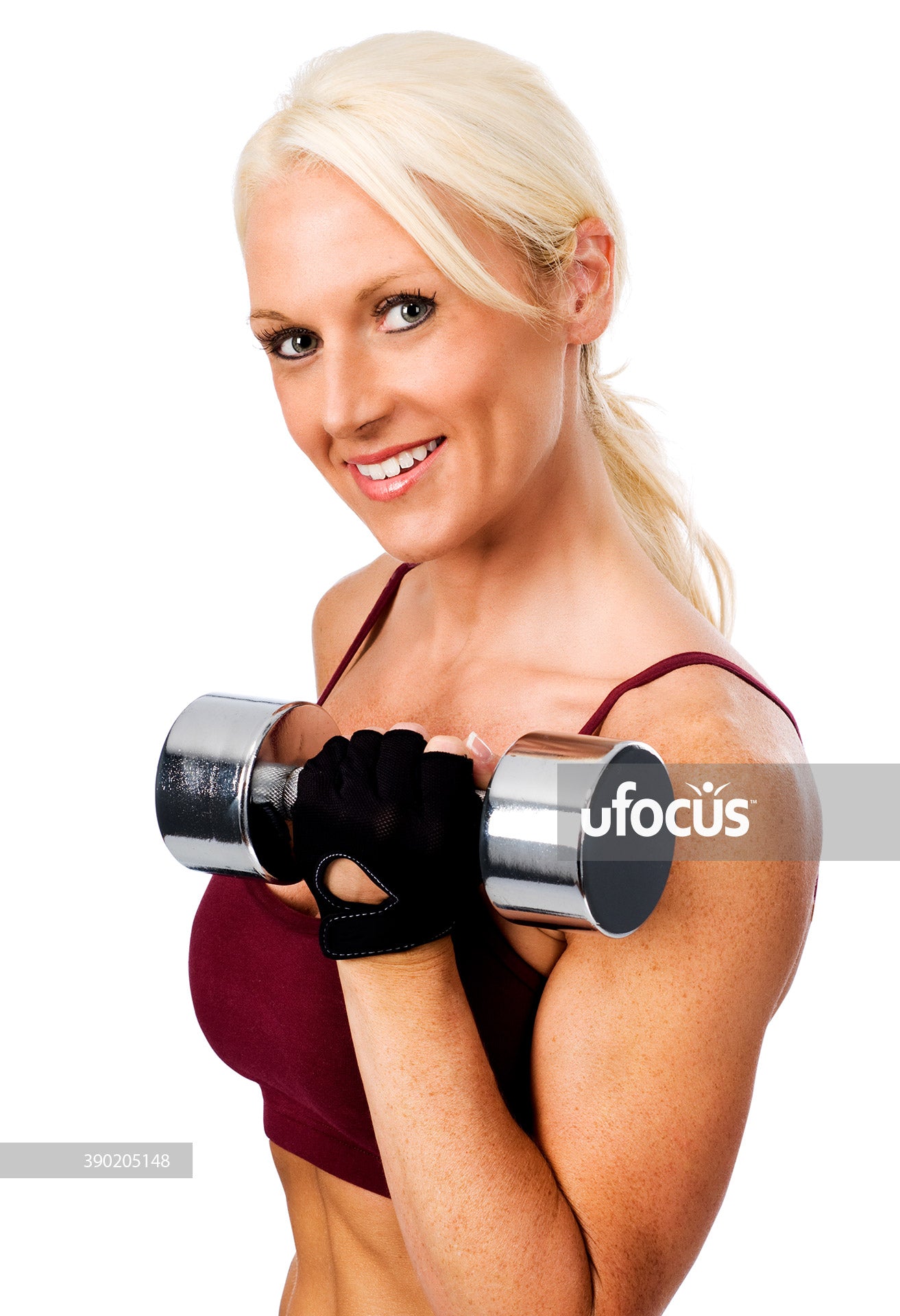 Beautiful woman fitness model holding weights